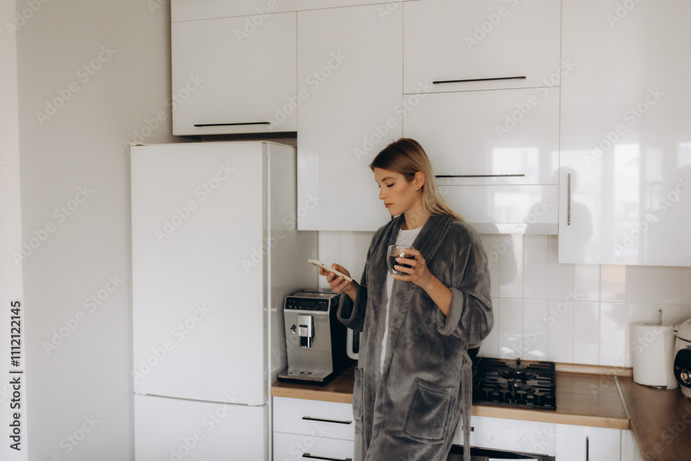 Young happy woman drinking coffee on the kitchen in the morning. Young happy woman drinking coffee on the kitchen in the morning.