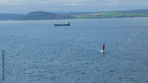 sailing vessel industrial ship background near searm scotland highlands scenic backdrop to maritime activity nautical operations coastal hub transport shipyard  photo