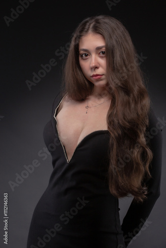 Fashion portrait of pretty woman in black dress