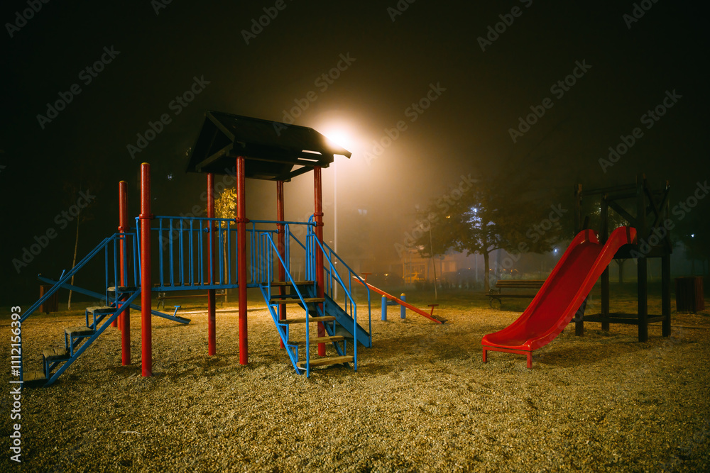 Empty playground at foggy winter night Empty playground at foggy winter night