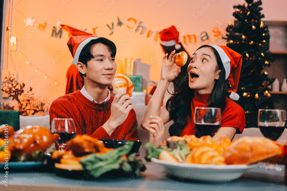 Group of young Asian man and women as friends having fun at a New Year's celebration, holding gift boxes standing by Christmas tree decoration, midnight countdown Party at home with holiday season. Group of young Asian man and women as friends having fun at a New Year's celebration, holding gift boxes standing by Christmas tree decoration, midnight countdown Party at home with holiday season.