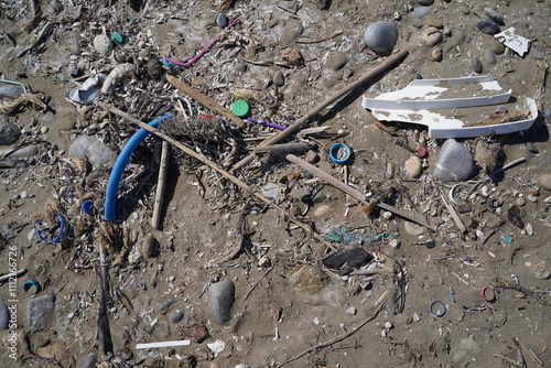 massive pile of trash on a sand beach  photo