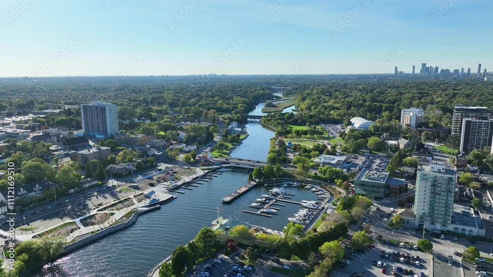 Drone flight over river in downtown city section in summer, with marina, boats ad residential apartments Drone flight over river in downtown city section in summer, with marina, boats ad residential apartments