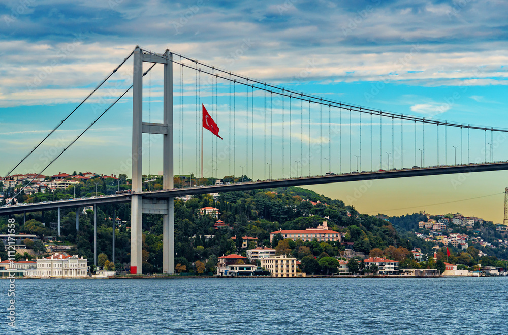 Fototapeta premium view from a pleasure boat on the Bosphorus and Bosphorus Bridge and cityscape of Istanbul, Turkey, the architecture of the city, a popular tourist destination.