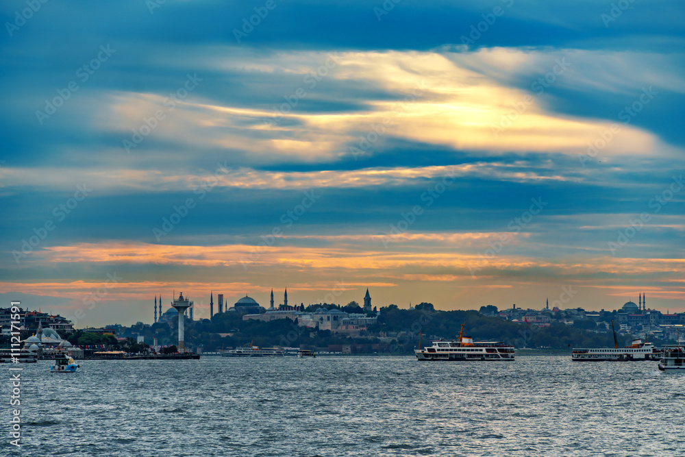 view from a pleasure boat on the Bosphorus and the cityscape of Istanbul, Turkey, the architecture of the city at sunset, a popular tourist destination. view from a pleasure boat on the Bosphorus and the cityscape of Istanbul, Turkey, the architecture of the city at sunset, a popular tourist destination.