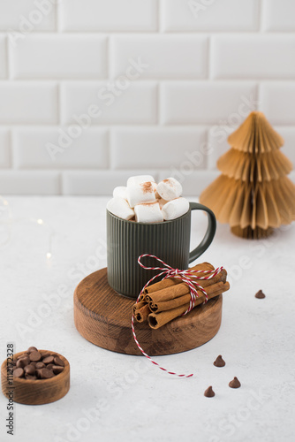 Photos New Year cocoa mug with marshmallows and cinnamon on round board
