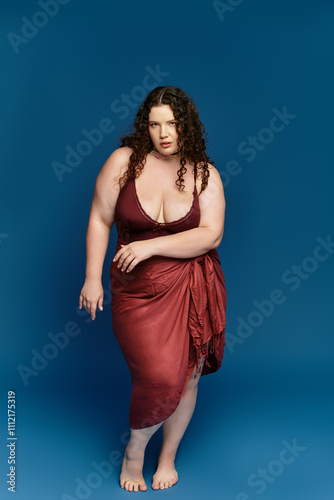 A confident young woman poses elegantly in trendy attire, radiating beauty and style.