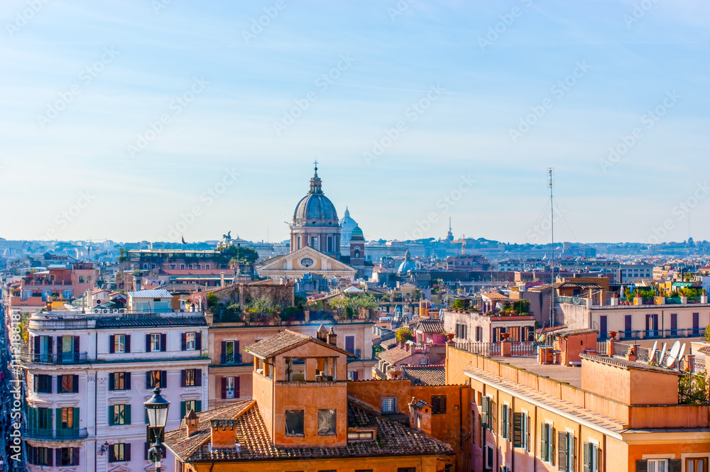 Fototapeta premium The view of old houses and the domes of historic Rome, Italy