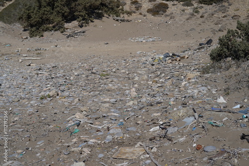 spread out trash on a sand beach photo