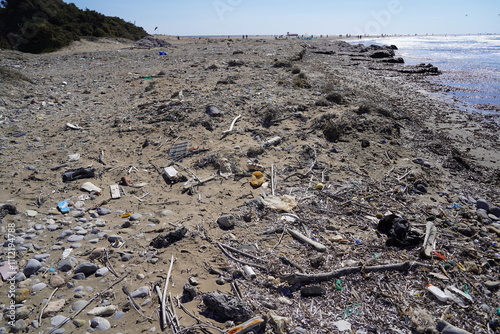 spread out trash on a sand beach photo