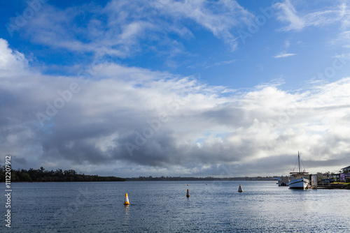 riverside views over water of Hastings river in Port Macquarie with historical ship docked photo