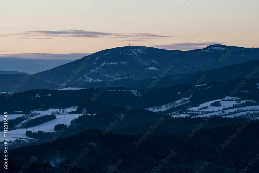 Colorful sunset over the Czech countryside. View of the Krkonoše mountains from the Teplice-Adršpašská rocks.