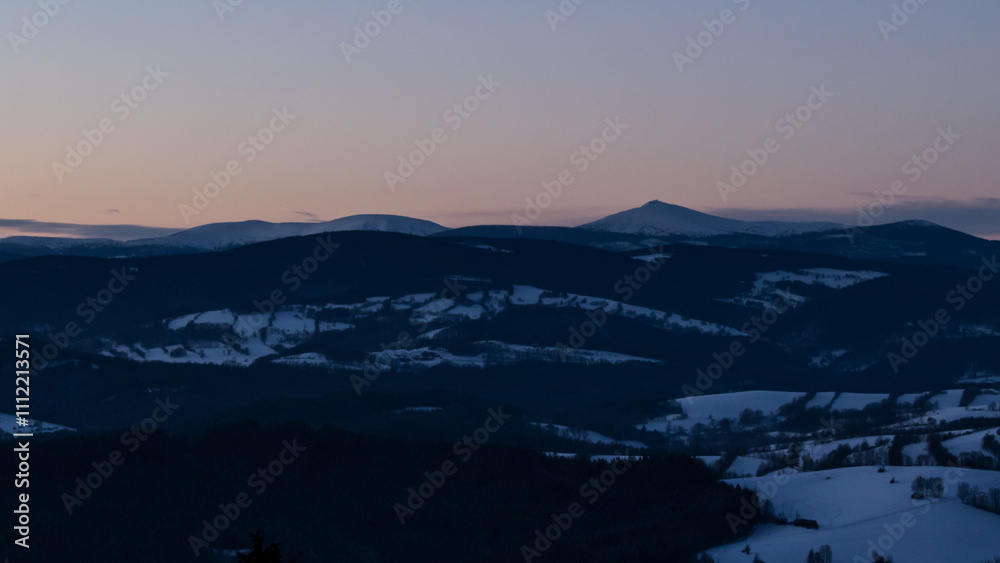 Colorful sunset over the Czech countryside. View of the Krkonoše mountains from the Teplice-Adršpašská rocks. Colorful sunset over the Czech countryside. View of the Krkonoše mountains from the Teplice-Adršpašská rocks.