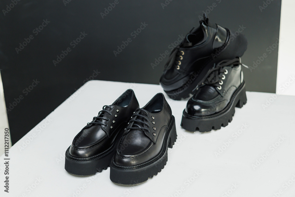 Women's leather stylish black loafers on a white background, women's summer shoes close-up. Fashionable shoes for women. Selective focus