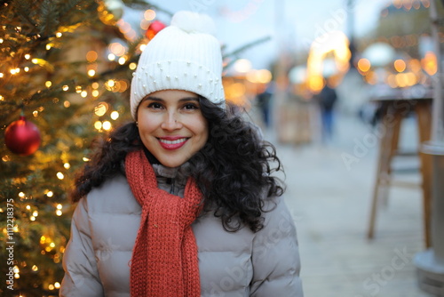 Beautiful ethnic woman walking around a christmas market 