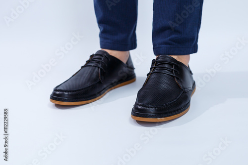 A man is wearing classic black shoes made of natural leather on lace, shoes for men under business style photo