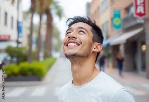 Young hispanic man smiling confident looking to the sky at street