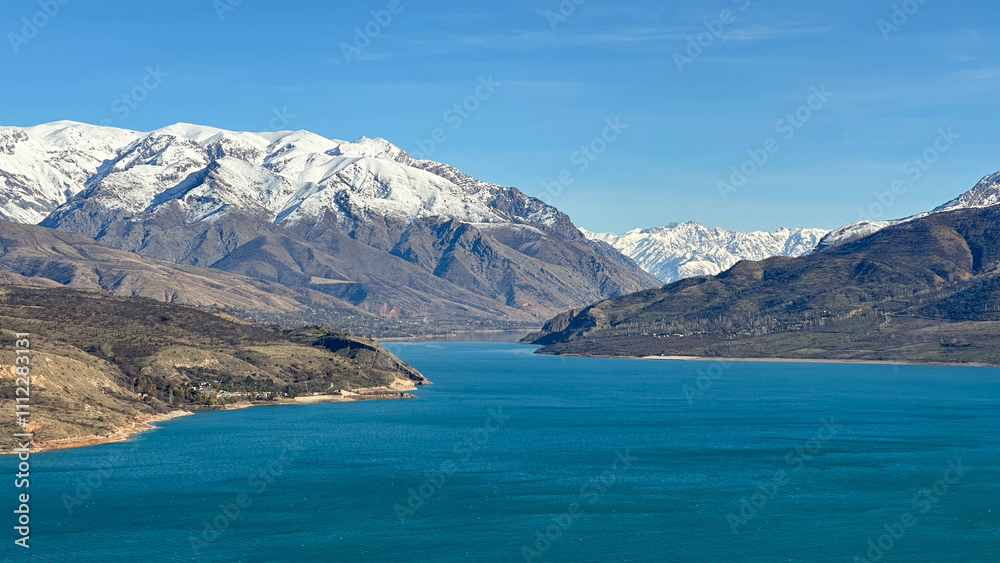 reservoir in the mountains with snowy peaks reservoir in the mountains with snowy peaks