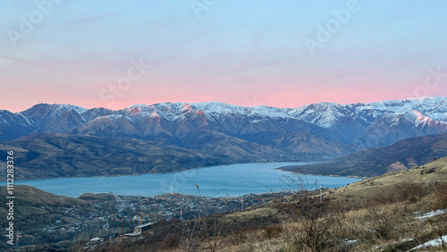 Snowy peaks mountains at the sunset