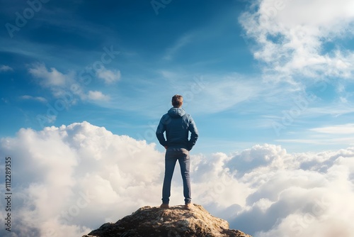 Confident Person Standing Tall on Mountain Peak Facing Dramatic Sky and Clouds