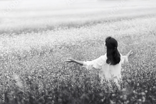 Quadro su tela Woman with arms wide open in joy, moved by beautiful natural scenery in a peacef