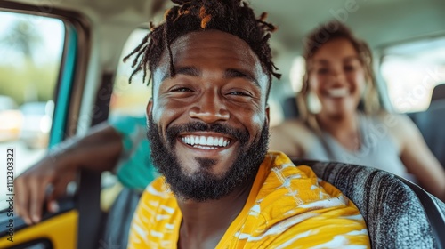 A vibrant scene showing a man joyously smiling in the car's front seat, surrounded by friends relishing a carefree and exciting road trip experience. photo