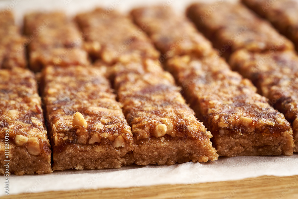 Close up of homemade no-bake healthy bars made of whey protein powder, peanut butter, maple syrup and dates Close up of homemade no-bake healthy bars made of whey protein powder, peanut butter, maple syrup and dates