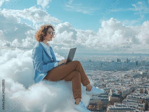 Focused woman using laptop on cloud with city view. photo