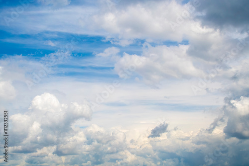 Background with calm blue sky and white cumulus clouds. Relaxing backdrop on the theme of weather and climate.