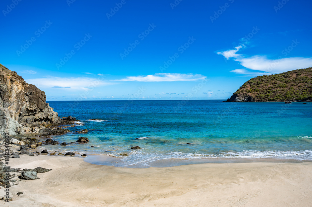 beautiful beach with a blue ocean and a mountain in the background beautiful beach with a blue ocean and a mountain in the background