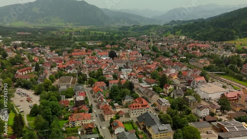 Aerial view of Immenstadt im Allgaeu, Bavaria, showcasing picturesque town surrounded by Bavarian Alps. With traditional buildings, rolling hills and alpine landscape, summer tourist destination.  photo