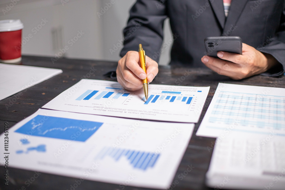 Accountants working on financial investments on calculators, calculating, analyzing business and marketing growth on graphs of various financial documents. Accountants working on financial investments on calculators, calculating, analyzing business and marketing growth on graphs of various financial documents.