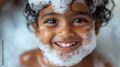 Happy Indian toddler with bubbles enjoys a playful bath time in a cheerful atmosphere