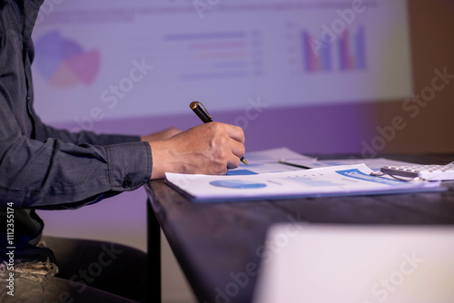 Accountants working on financial investments on calculators, calculating, analyzing business and marketing growth on graphs of various financial documents.