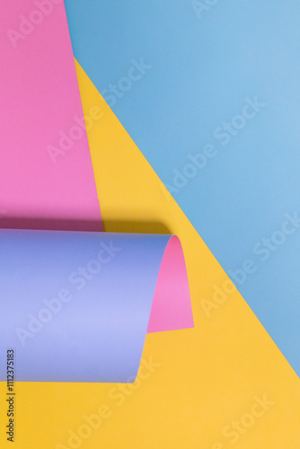 Paper design, blue, pink, yellow, purple. Wrapped roll, copy space background