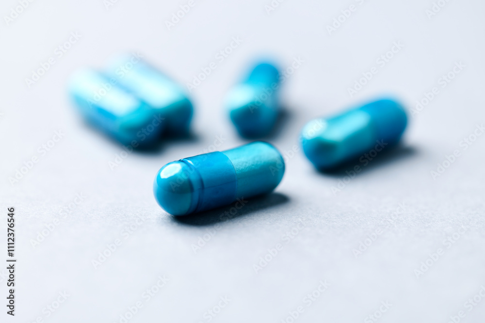 Amino acids capsules on paper background. Soft focus. Close up. Copy space. Amino acids capsules on paper background. Soft focus. Close up. Copy space.