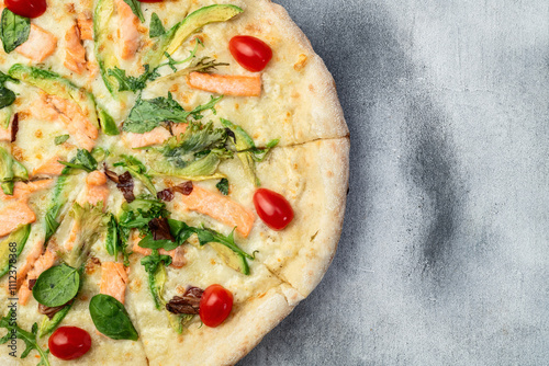 Italian pizza with avocado salmon  tomatoes and mozzarella photography. top view photo