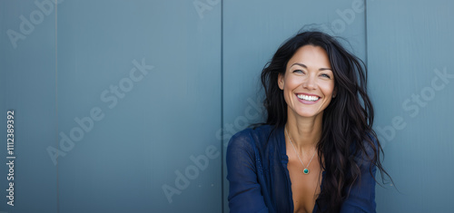 Business woman enjoying a moment of joy with a joyous laugh in a modern office setting during a sunny day