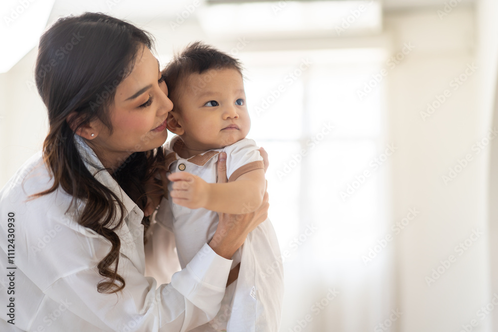 Portrait of enjoy happy love family asian mother playing with adorable little asian baby.Mom touching with cute son moments good time in a white bedroom.Love of family concept Portrait of enjoy happy love family asian mother playing with adorable little asian baby.Mom touching with cute son moments good time in a white bedroom.Love of family concept