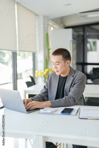 Asian Business man working with laptop. Young business man thinking Concentrated at work.