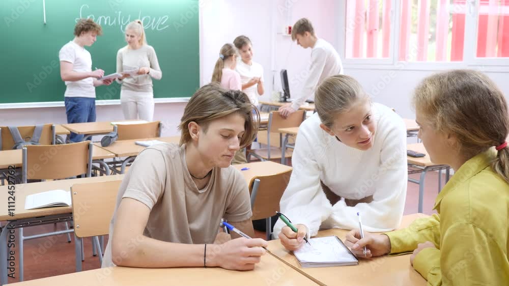 Schoolchildren study together in group lessons in the school class