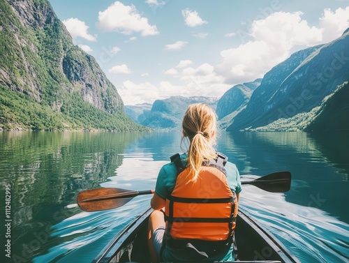 view from the back of a girl in a canoe, gently gliding through tranquil waters, surrounded by stunning fjords, capturing a moment of adventure and connection with nature under a clear blue sky