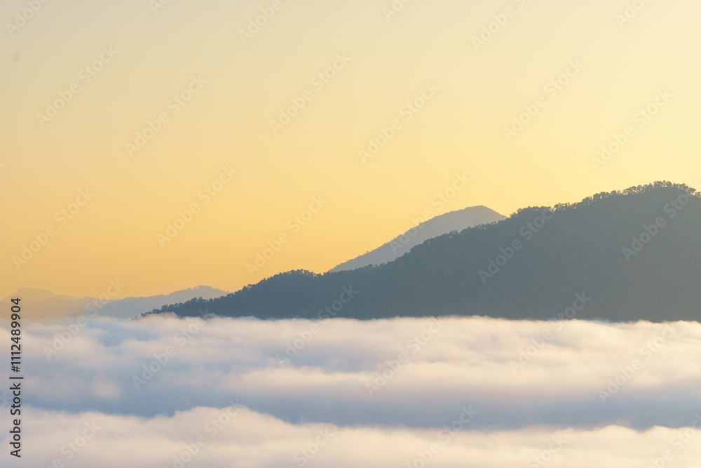 Fototapeta premium Breathtaking mountain landscape above clouds at sunrise