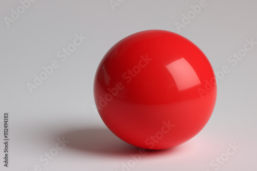 A red ball on a white background. A ball with red and gray background. Ball red gray background toy circle. A toy ball with a gray background and a circle lifestyle.