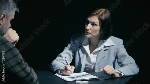 Obraz na płótnie Male crime suspect hands money to an investigator, while a female detective acce
