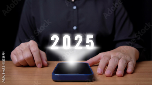 Woman uses hand touch to change data from 2024 to 2025