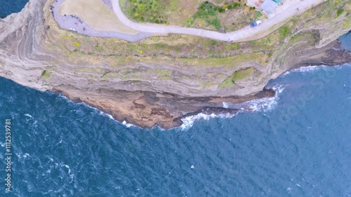 The beautiful harmony of Songaksan Dulle-gil, the sea, and cliffs in Jeju Island, Korea, and the natural scenery taken from the sky with drones