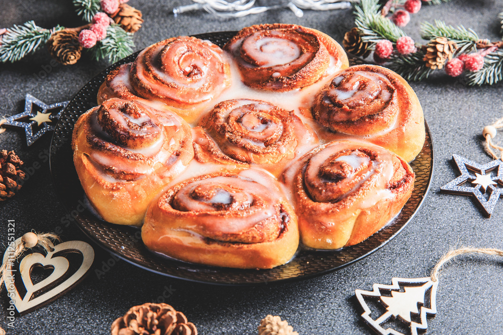Cinnamon Rolls brioches or cinnamon rolls with icing sugar and cream cheese - decorated for Christmas
