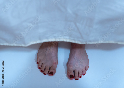 Photos Veiled Mystery: Red Toenails Behind the Curtain