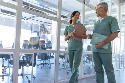 Two doctors walking in the clinic corridor and talking